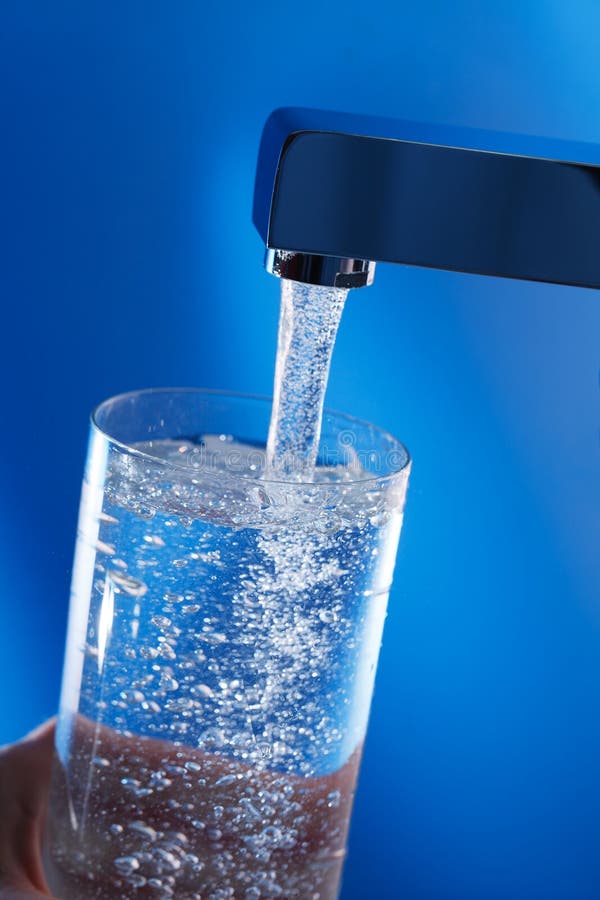 Filling up a glass of water .