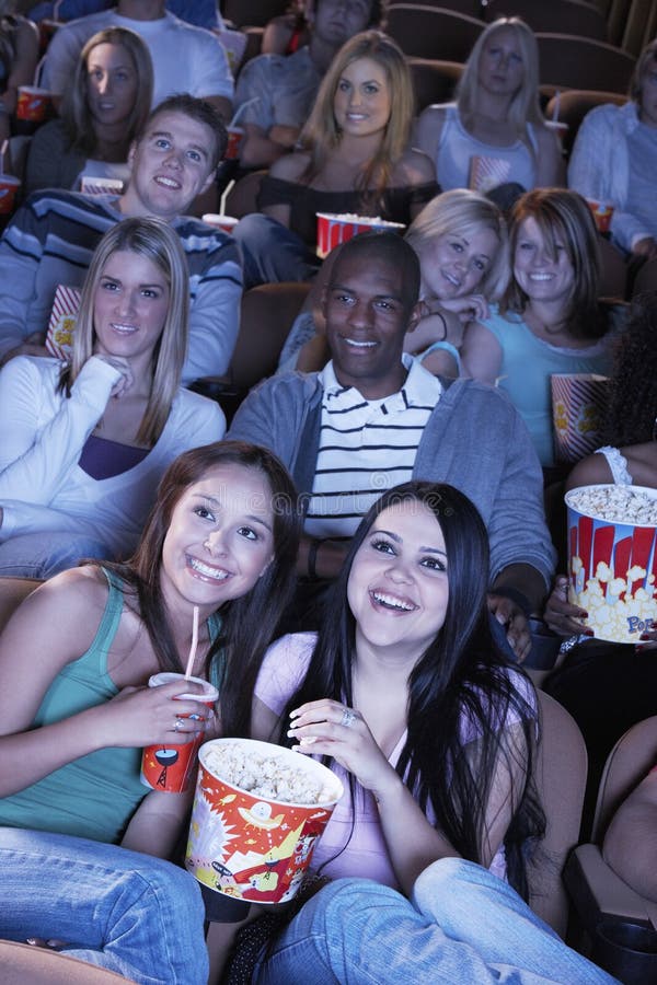 Group of multiethnic people watching film in movie theater. Group of multiethnic people watching film in movie theater