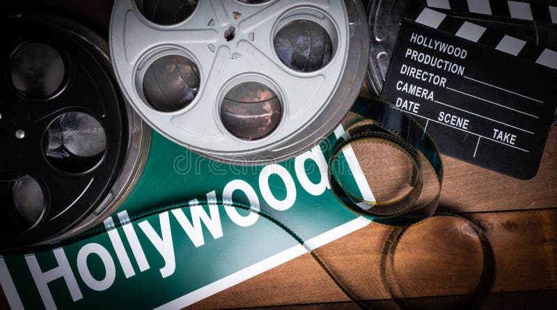 Film Reel and Clapboard. Hollywood, Entertainment Industry Background on a  Wood Table Stock Photo - Image of entertainment, board: 146986126