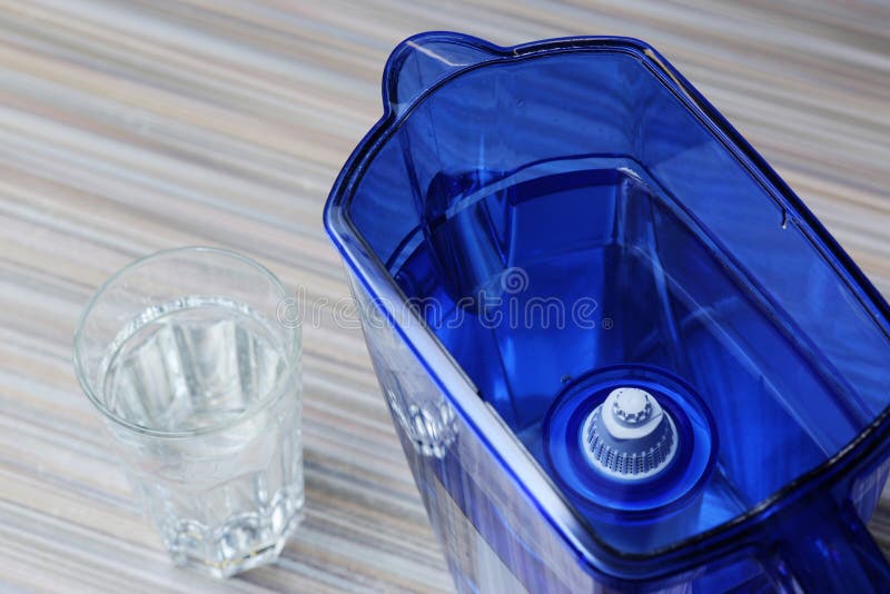 Filter for cleaning drinking water on the table in the kitchen. Purification of drinking water at home