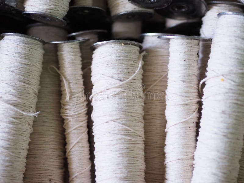 Textile threads industry cotton sewing spools close up. Textile threads industry cotton sewing spools close up