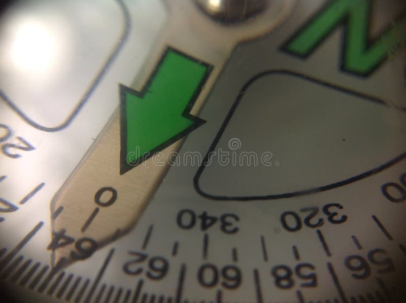 North compass point needle showing north and west direction and degrees numbers with green arrow and black and white marks. North compass point needle showing north and west direction and degrees numbers with green arrow and black and white marks.