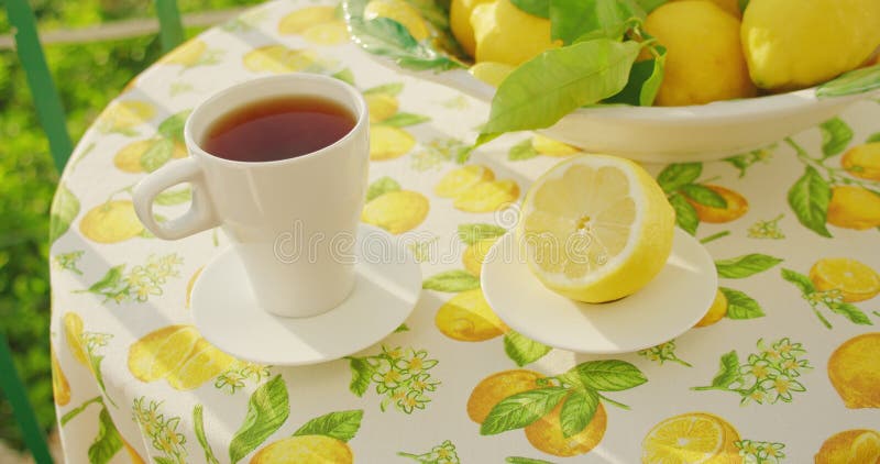 The final tea preparation reveals a steeped drink beside a halved lemon. Warm rays illuminate still life, highlighting. The tranquil morning ritual