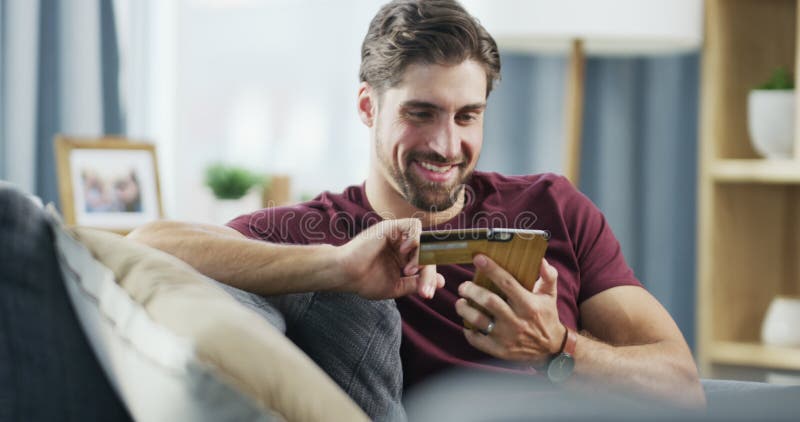 Finally ordering those cool sneakers. 4k video footage of a handsome young using a smartphone and a credit card to shop stock video