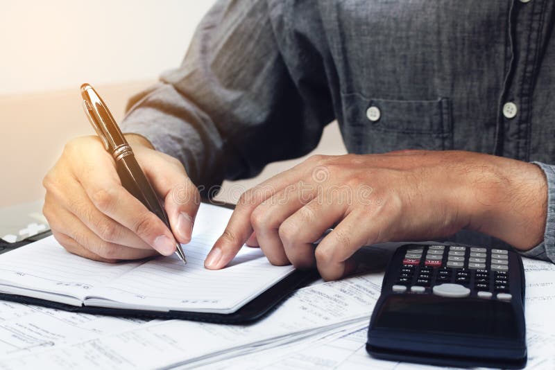 Finance Concept. Man Writing and Make Note about Cost and Expenses at