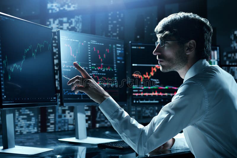 Financial analyst pointing at the computer monitor. stock photo