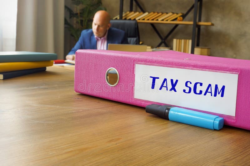 Financial concept about TAX SCAM with phrase on the File Folder stock photos