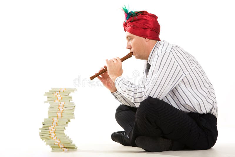 Image of entrepreneur playing the pipe with high stack of dollar bills in front. Stack decrease stock images, royalty-free photos and pictures