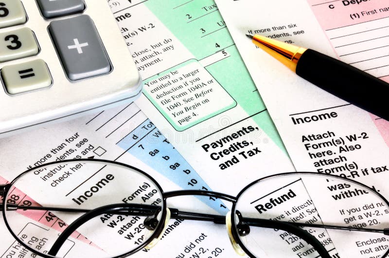 Financial papers with calculator, glasses and pen