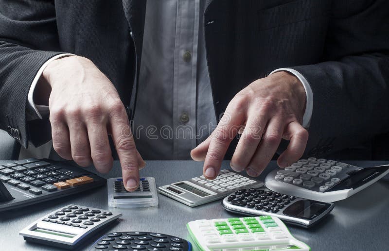 Financial professional or accounting at work with calculators royalty free stock photos Financial professional or accounting at work with calculators royalty free stock photos