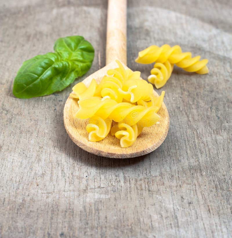 Fine fusilli noodles stock photo. Image of spoon, board 61892568