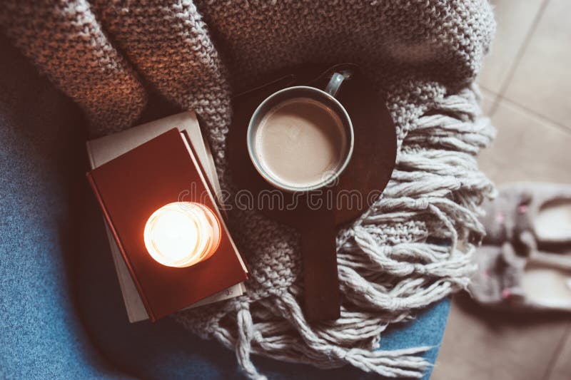 Cozy winter weekend at home. Morning with coffee or cocoa, books, warm knitted blanket and chair. Hygge concept. Cozy winter weekend at home. Morning with coffee or cocoa, books, warm knitted blanket and chair. Hygge concept.