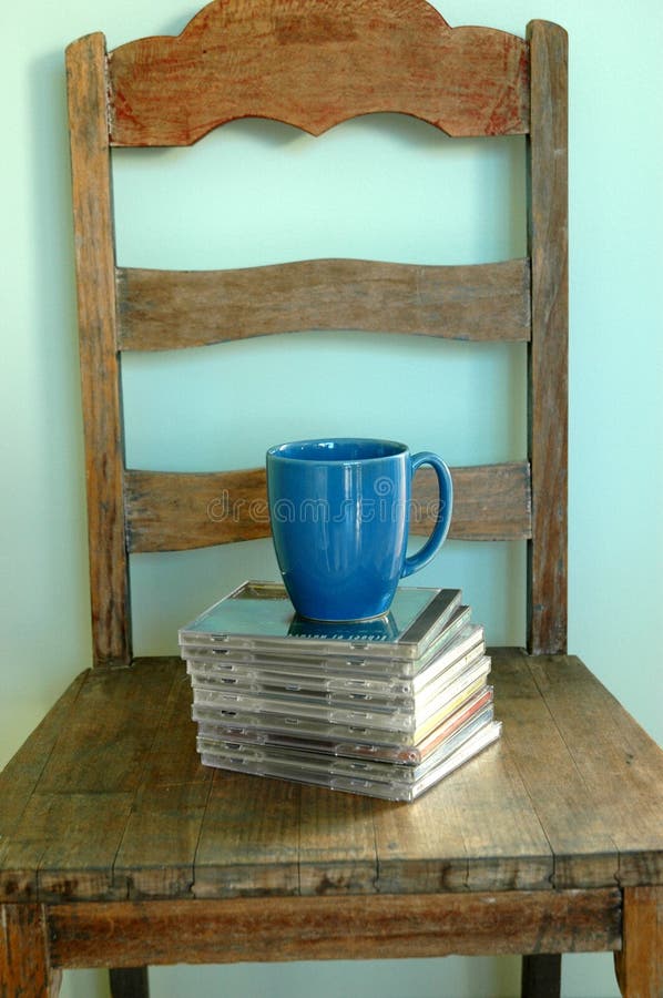 Home Interior, CD's sitting on an old chair with a blue mug of coffee. Home Interior, CD's sitting on an old chair with a blue mug of coffee.