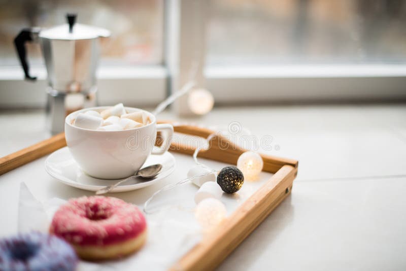 Cozy home weekend, coffee and sweets in tray on floor, warm winter indoors. Cozy home weekend, coffee and sweets in tray on floor, warm winter indoors