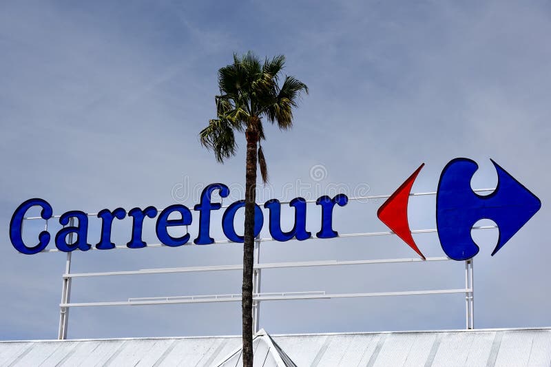 Finestrat, Spain - April 9, 2024: Carrefour logo sign on Carrefour supermarket on sky background. Carrefour is French multinational retail and wholesaling corporation. Finestrat, Spain - April 9, 2024: Carrefour logo sign on Carrefour supermarket on sky background. Carrefour is French multinational retail and wholesaling corporation.