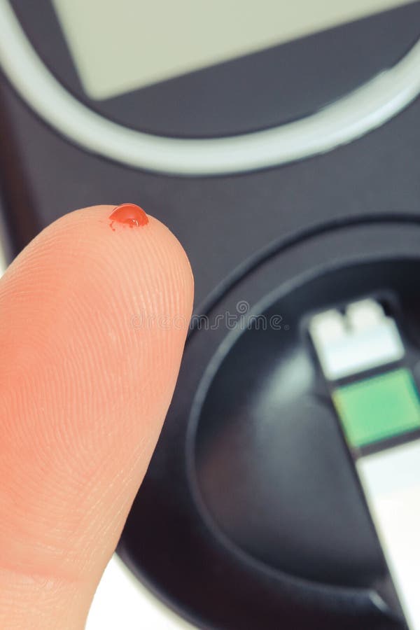 Finger with Blood and Glucose Meter. Checking Sugar Level Concept Stock