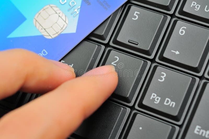 Finger and credit card on keypad