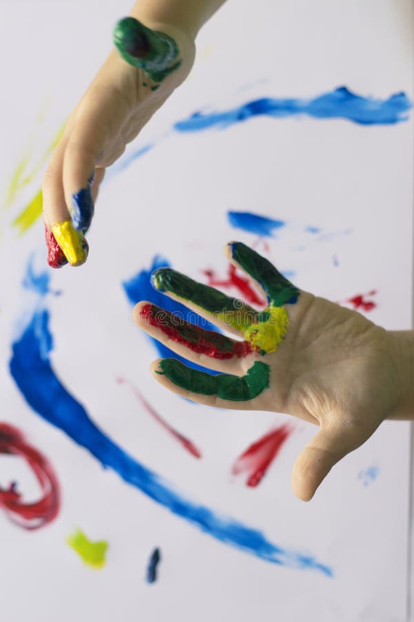 Hand of child while doing fingerpaint. stock image Hand of child while doing fingerpaint. stock image
