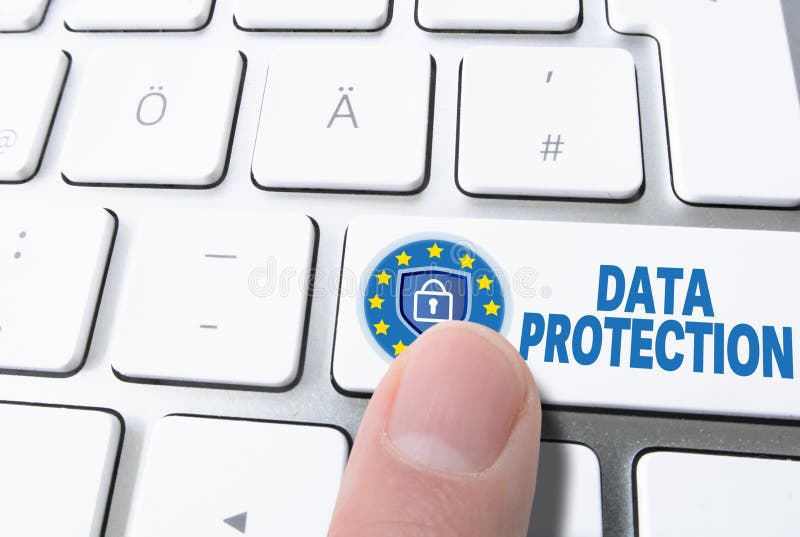 Finger pressing key labled DATA PROTECTION on computer keyboard royalty free stock image
