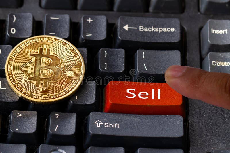 The finger pressing the sell button on the computer keyboard, believing bitcoin has changed the trend will sell. Keyboard sell stock images, royalty-free photos and pictures