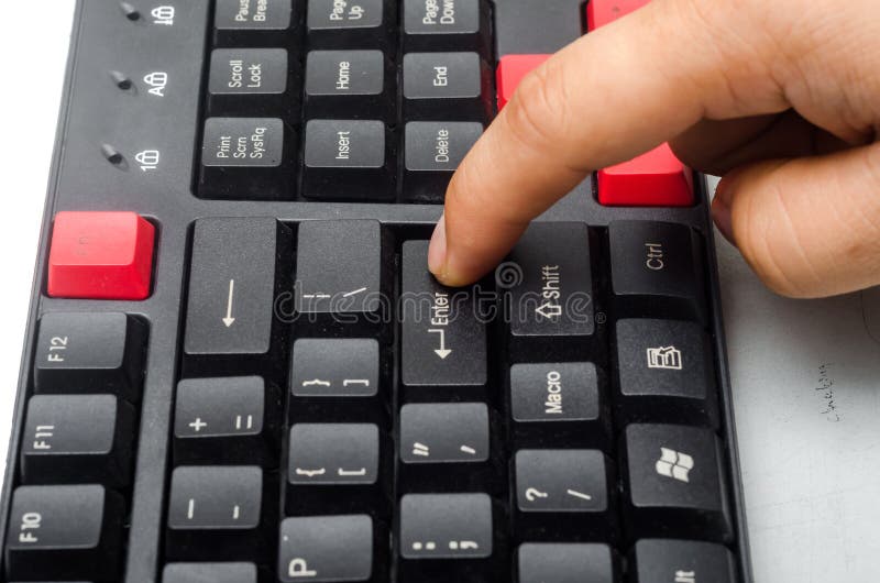 Finger pushing the button ENTER stock photography