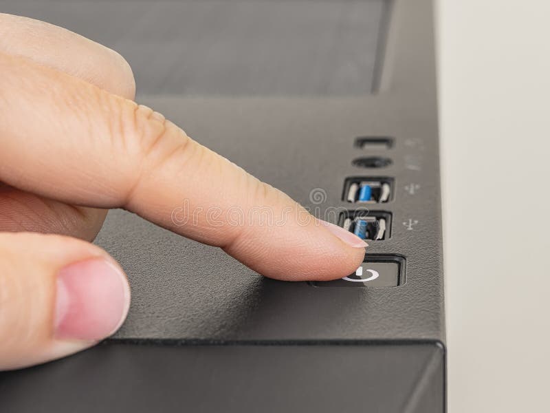 Finger is ready to press down the On Off button on the personal computer system unit. Power button on the top of desktop PC tower royalty free stock photos
