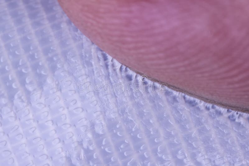 Finger Stuck and Pulling Away from Surface of Piece of Sticky Tape