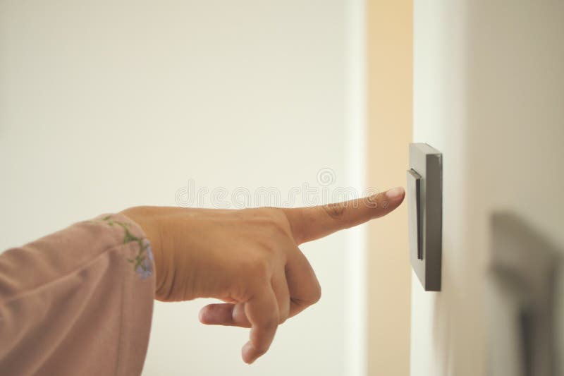 A finger turning on lighting switch. stock image