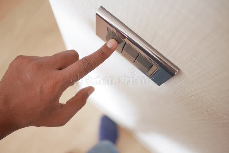 A finger turning on lighting switch. royalty free stock photo