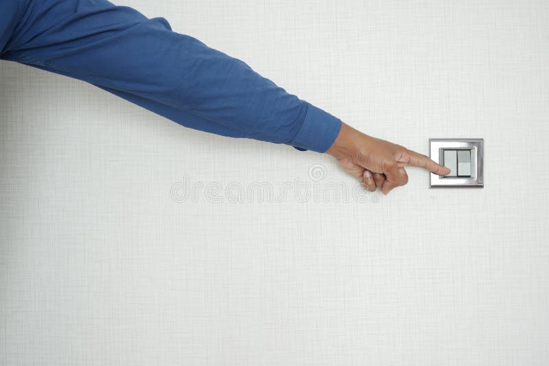A finger turning on lighting switch. stock image