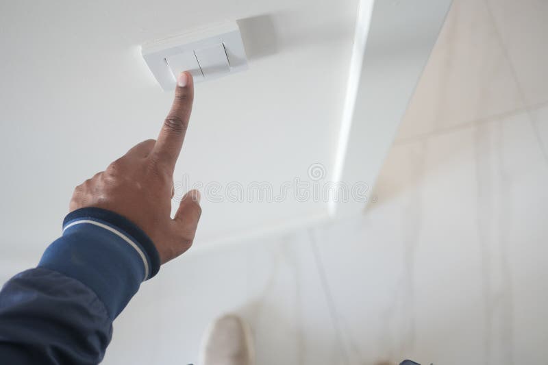 A finger turning on lighting switch. stock image