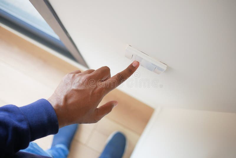 A finger turning on lighting switch. royalty free stock image