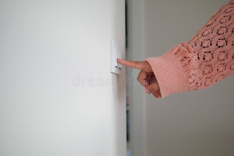 A finger turning on lighting switch. royalty free stock photography