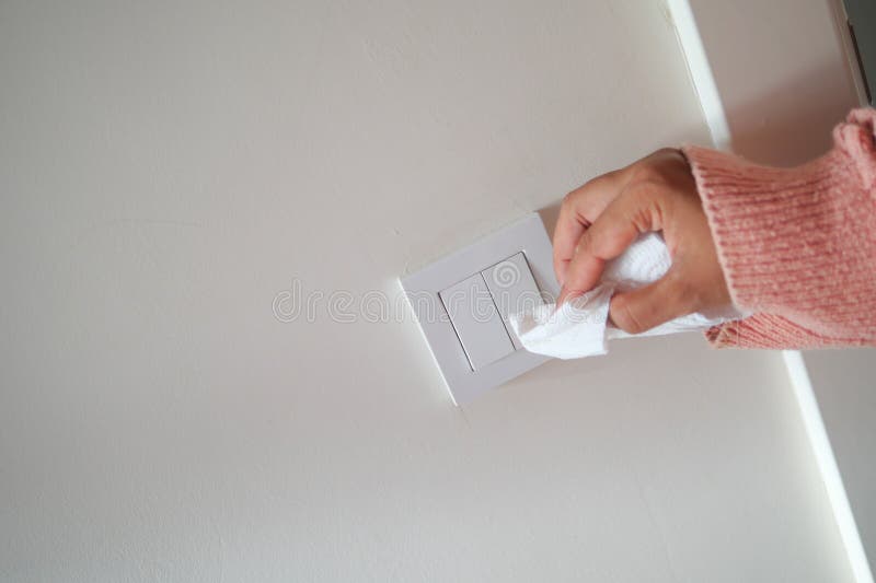 A finger turning on lighting switch. royalty free stock photo