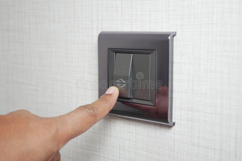 A finger turning on lighting switch. royalty free stock images