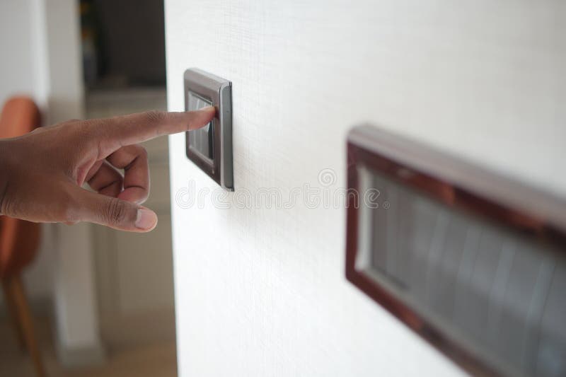 A finger turning on lighting switch. royalty free stock photography