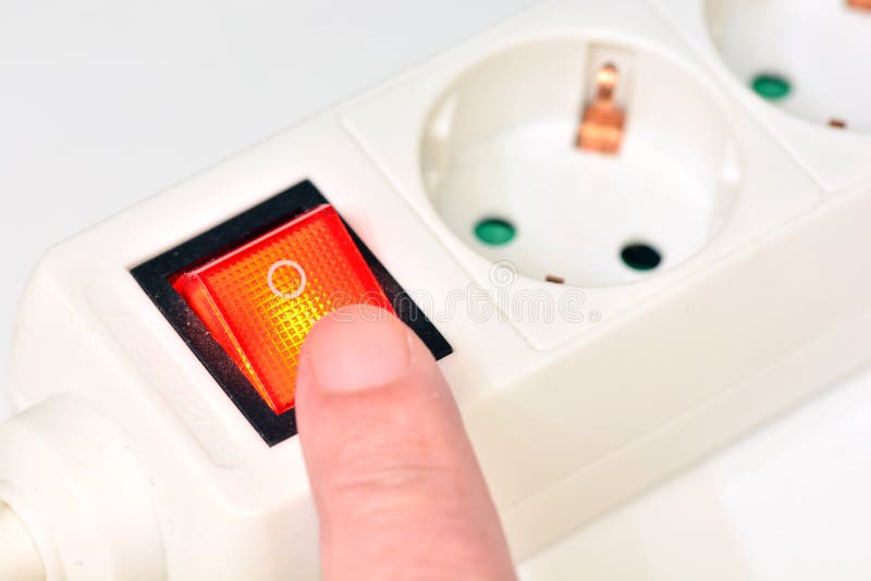 Finger turning off the power connector button stock photography