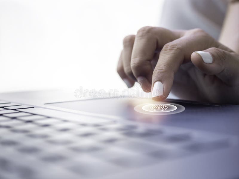 Fingerprint Scan Icon on Touchpad on Laptop Computer while Finger