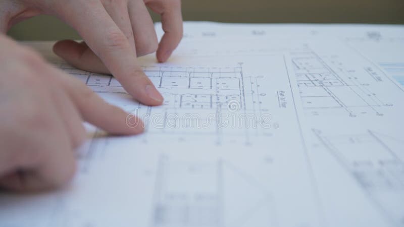 The fingers of a human being show circuit on the printed document.