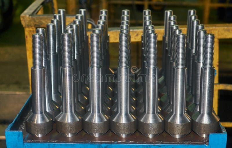 Finished metal shafts with threaded with CNC stand on metal table