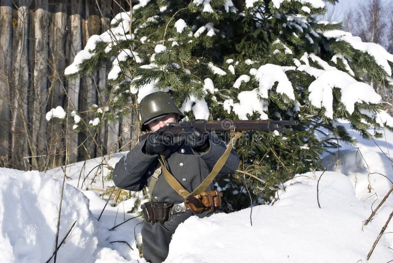 Finnish soldier aims from a rifle