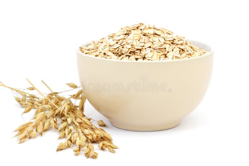 Fiocchi di avena in una ciotola della porcellana fotografia stock libera da diritti Fiocchi di avena in una ciotola della porcellana fotografia stock libera da diritti