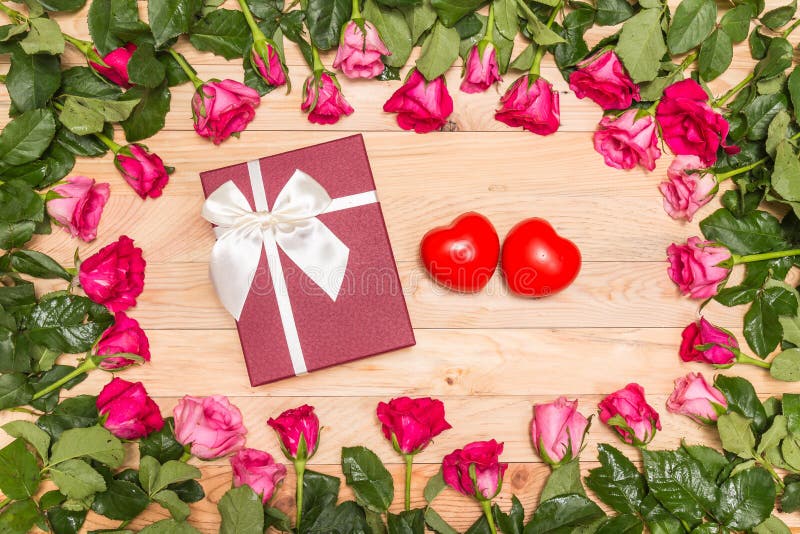 Top view fresh pink rose flower and gift box on wooden deck. For love or valentine day concept. Top view fresh pink rose flower and gift box on wooden deck. For love or valentine day concept