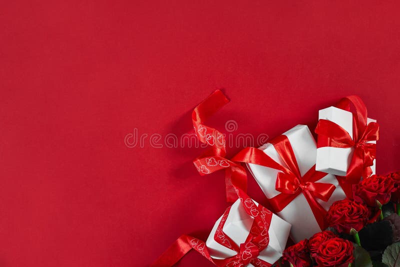 Top view fresh red rose flower and gift box on red deck with empty space for design. For love or valentine day concept. Top view. Copy space. Still life. Flat lay. Top view fresh red rose flower and gift box on red deck with empty space for design. For love or valentine day concept. Top view. Copy space. Still life. Flat lay