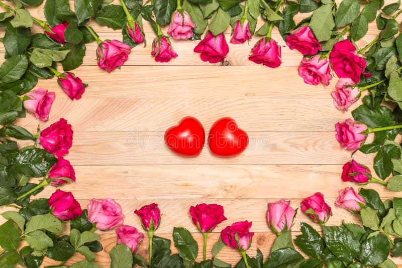 Top view fresh pink rose flower and red heart on wooden deck. For love or valentine day concept. Top view fresh pink rose flower and red heart on wooden deck. For love or valentine day concept