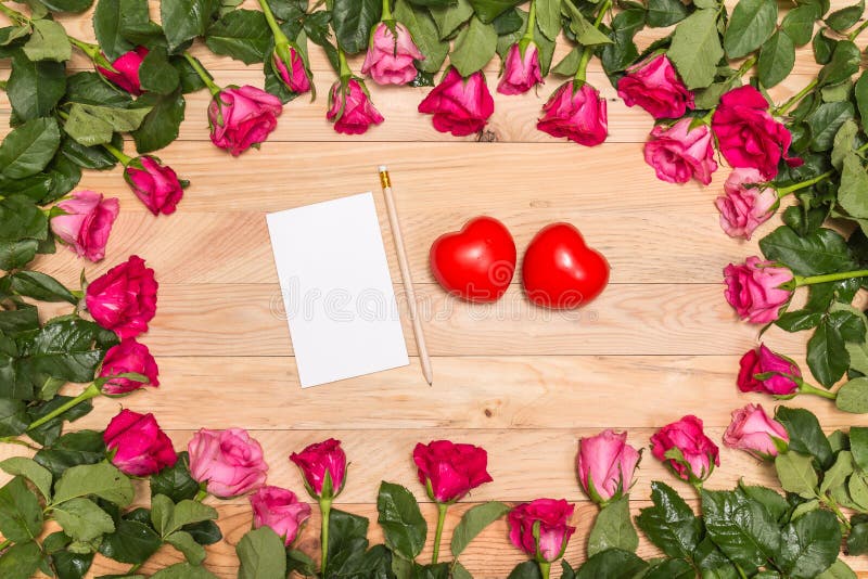 Top view fresh pink rose flower and red heart on wooden deck. For love or valentine day concept. Top view fresh pink rose flower and red heart on wooden deck. For love or valentine day concept