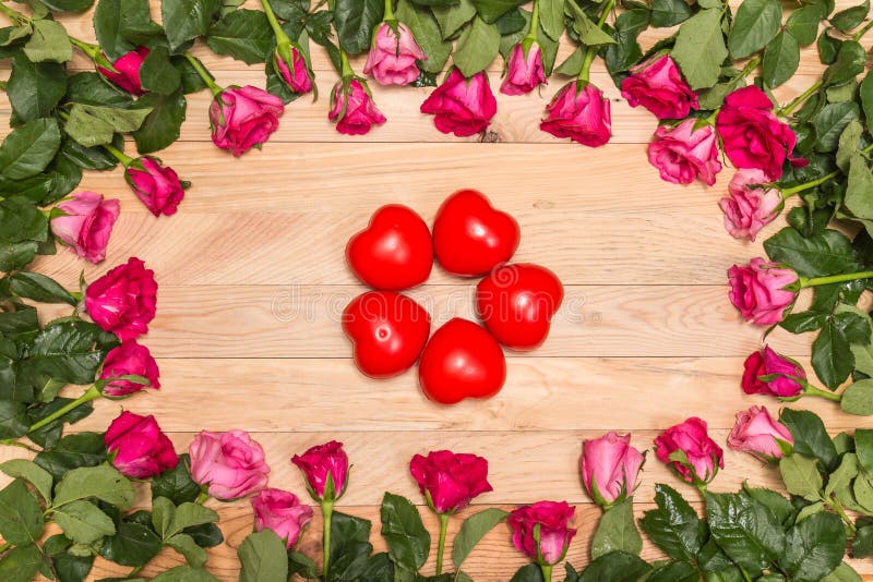 Top view fresh pink rose flower and red heart on wooden deck. For love or valentine day concept. Top view fresh pink rose flower and red heart on wooden deck. For love or valentine day concept