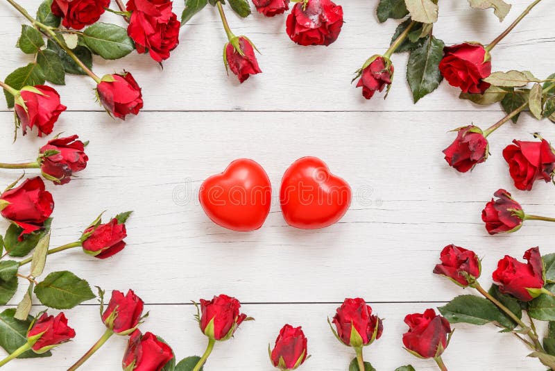 Top view fresh red rose flower and two red heart on white wooden deck with empty space for design. For love or valentine day concept. Top view fresh red rose flower and two red heart on white wooden deck with empty space for design. For love or valentine day concept