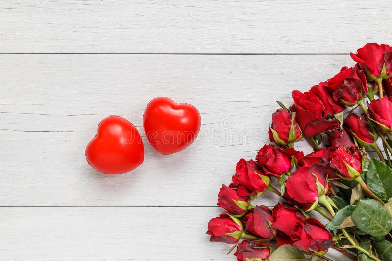 Top view fresh red rose flower and two red heart on white wooden deck with empty space for design. For love or valentine day concept. Top view fresh red rose flower and two red heart on white wooden deck with empty space for design. For love or valentine day concept