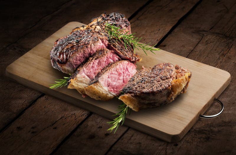Fiorentina Tbone Steak Cut on Rectangular Wooden Chopping Board and